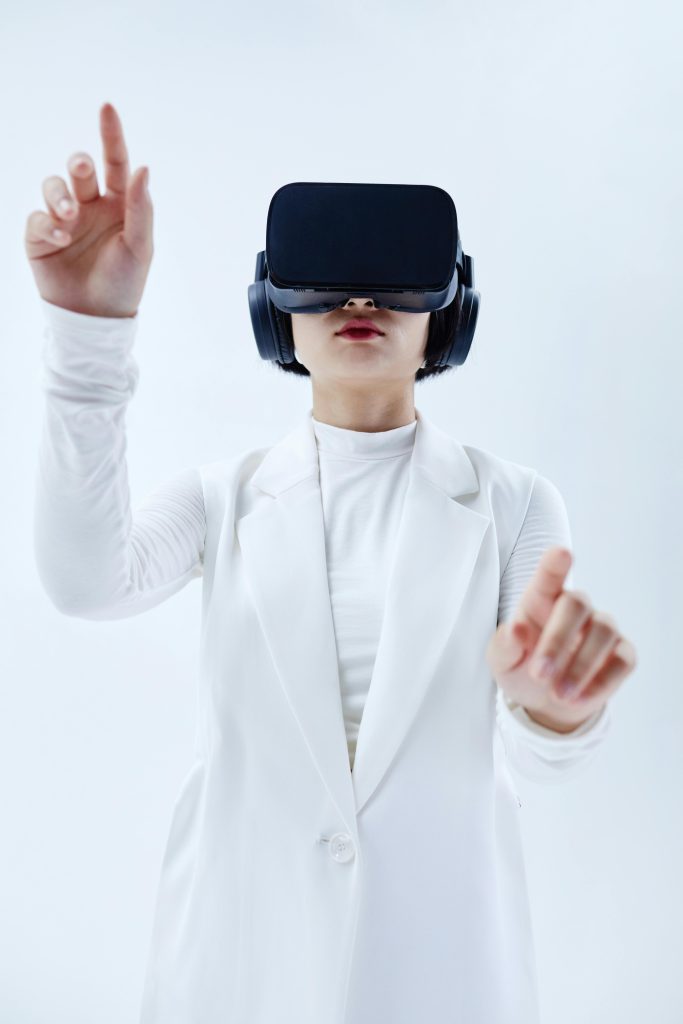 pexels-photo-8728223-8728223 Woman using VR headset, exploring technology in a white setting.