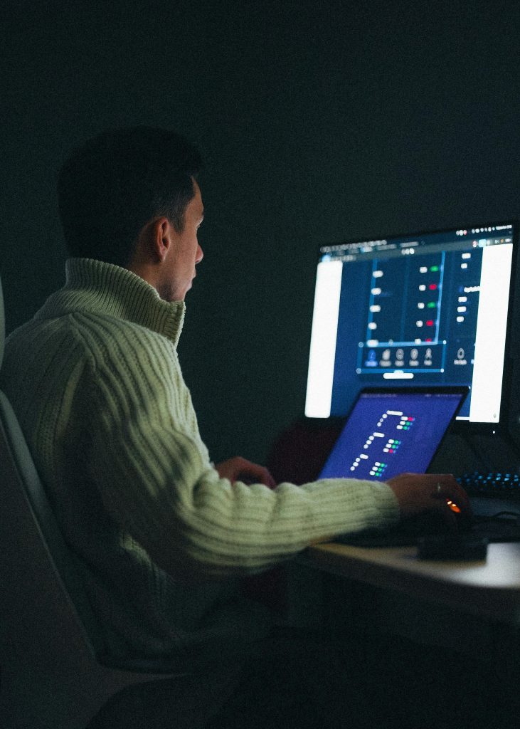 pexels-photo-20291643-20291643 Adult male working on a computer at night in a dark room.