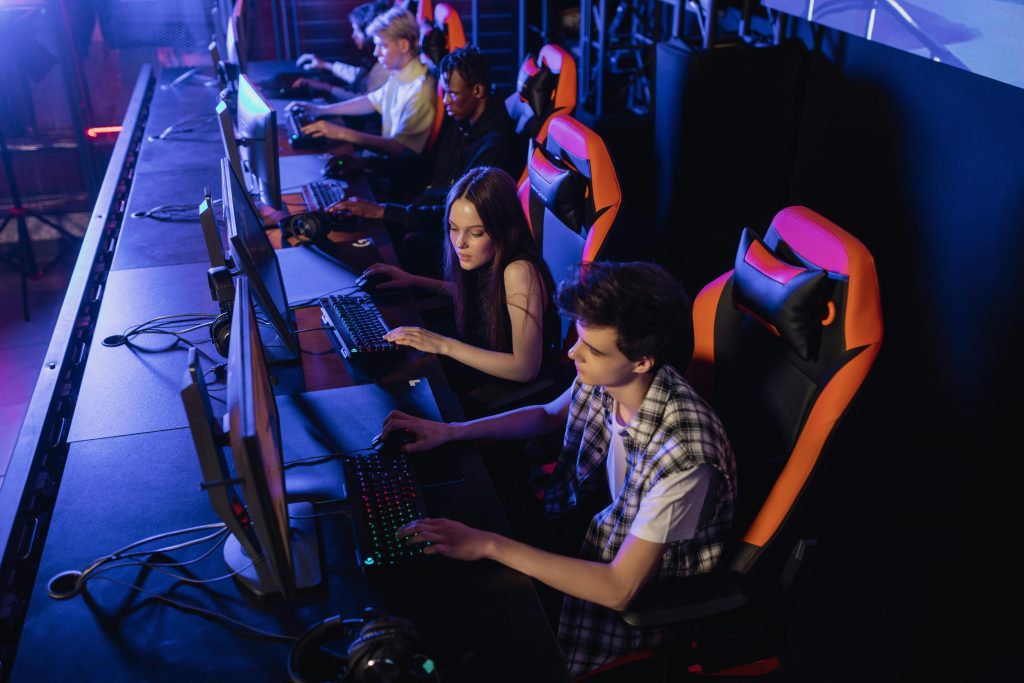 Teenagers engaged in a competitive gaming session at an indoor LAN event.